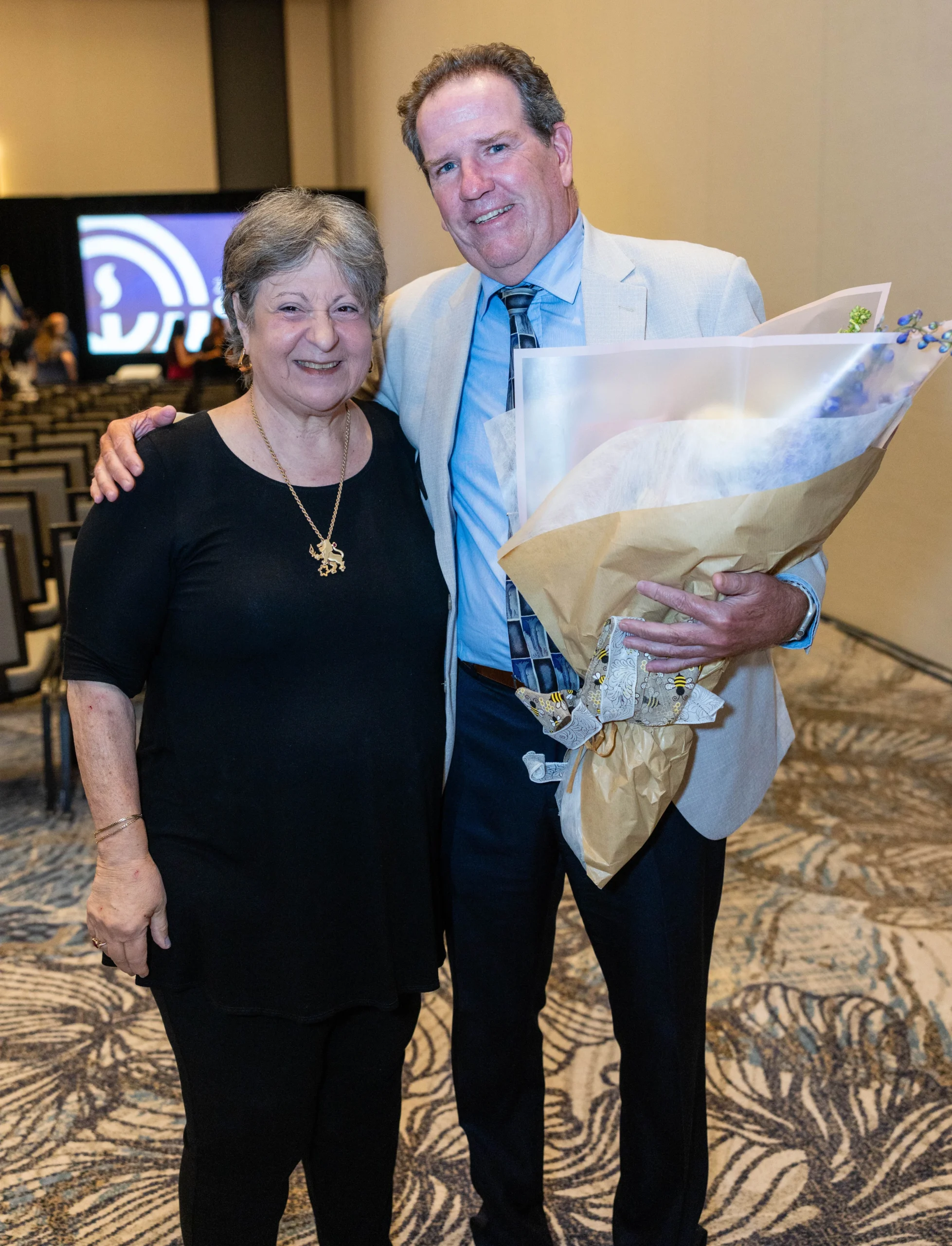 Patrick Travers receives the Debbie Roshfeld Professional Leadership Award with Debbie Roshfeld